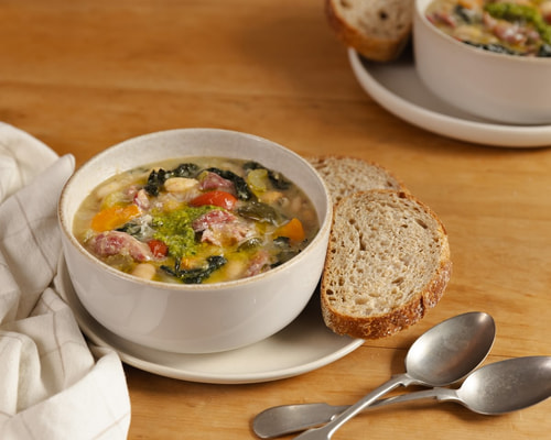 Tuscan style hearty vegetable soup with bacon hock